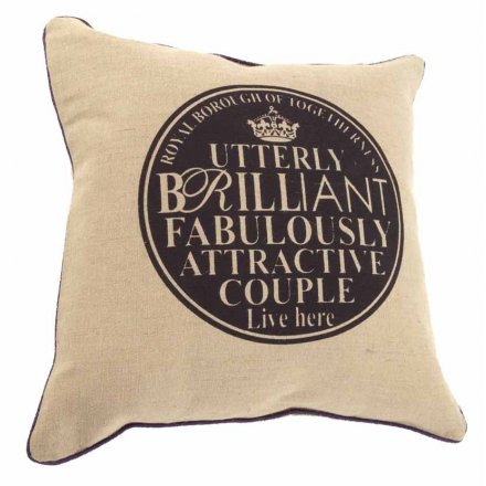 Chic natural cushion with printed couple plaque reading 'utterly brilliant, fabulously attractive couple lives here'. 