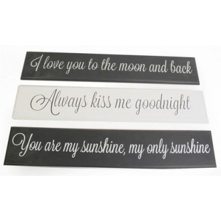 An assortment of three wooden signs, each with loving script
