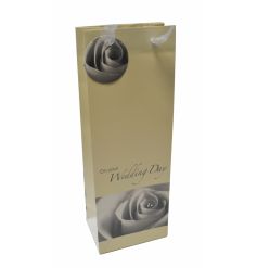 An elegant cream bottle bag with rose illustration and a touch of sparkle. 