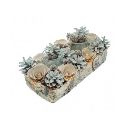 A natural bark tray with two glass t-light holders set within a wooden pinecone and floral display.