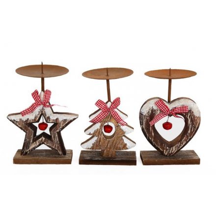 A random assortment of 3 chunky wooden candle holders with a red hanging bell, gingham bow and dusty snow finish.