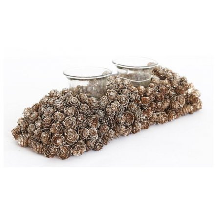 A sparkling double t light holder with champagne coloured glitter pinecone decorations.