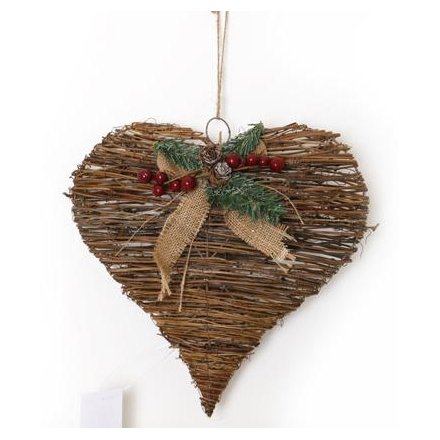 A rustic heart shaped wreath with a festive hessian bow decorated with berries.