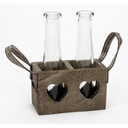 Two glass vases in a rustic wooden tray with heart cut out
