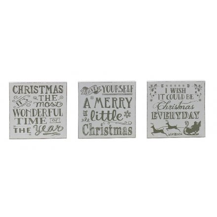 A mix of 3 silver glitter and white xmas block signs with popular slogans and festive illustrations.