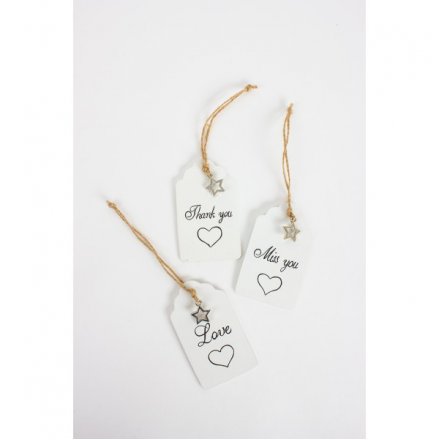 A mix of 3 hanging tag style signs with jute string and star and heart designs. 
