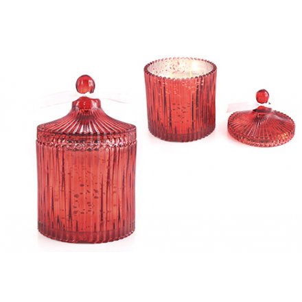 An antique style red glass candle pot with a cinnamon clove scented candle.