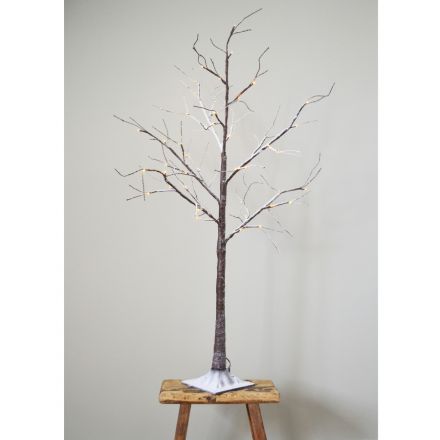 A pretty LED light up twig tree with a festive snowy finish