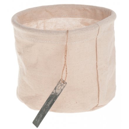 Fabric storage basket in a natural cream colour with metal tag