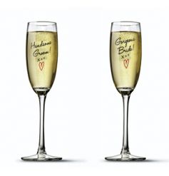 Champagne shoots in a sweet set with Bride and Groom script