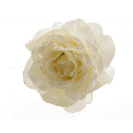 A chic white rose on a clip with glitter and sequin embellishments