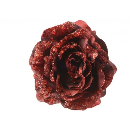 A rich red artificial rose on a clip with glitter and sequin embellishments.