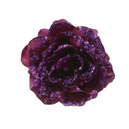 A luxurious purple rose on a clip with glitter and sequin embellishments.