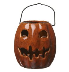 A pumpkin style lantern in a haunting design with handle 