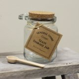 Glass storage jar with decorative cork lid and spoon to match