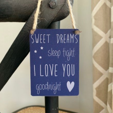 A hanging metal dangler sign with popular sweet dreams quote