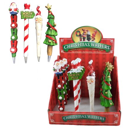 An assortment of colourful Christmas pens in a counter display unit