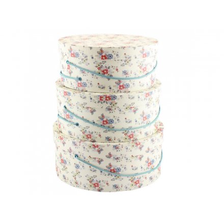 Stylish and practical hat boxes with blue string handles and a pretty summer daisy print.