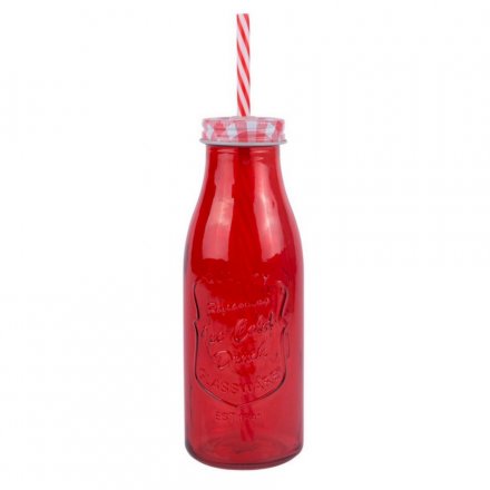 A deep red milk bottle with a matching straw