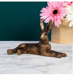 A stunning bronze hare ornament in a lying pose. A popular and on trend decorative accessory for the home.