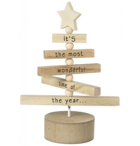 A rotating alpine Christmas tree with a star topper and Christmas slogan.