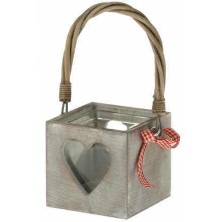 A shabby chic wooden lantern with heart cut out design and red gingham ribbon. Complete with willow handle.