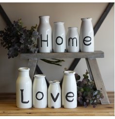 Set of four bottles with Love and Home text