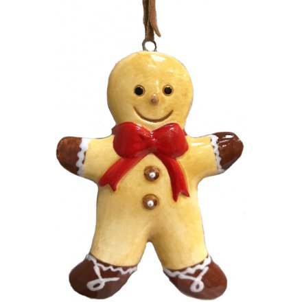 A traditional gingerbread man decoration with a large red bow and smiling face. Complete with a PU leather brown hanger.