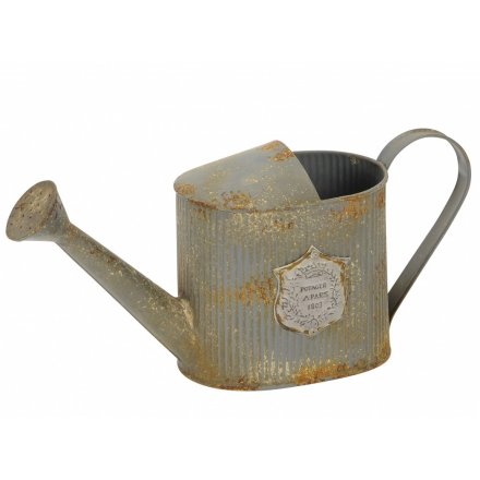 An antique inspired rustic watering can with Paris emblem. A rustic garden accessory, which is also ideal for planting.
