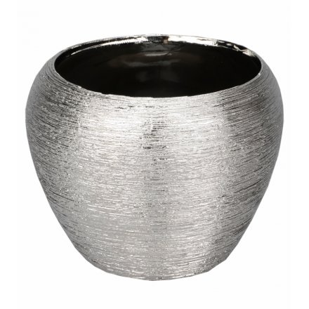 A silver decorative vase with a textured finish. A stylish home accessory which looks lovely displayed as pictured