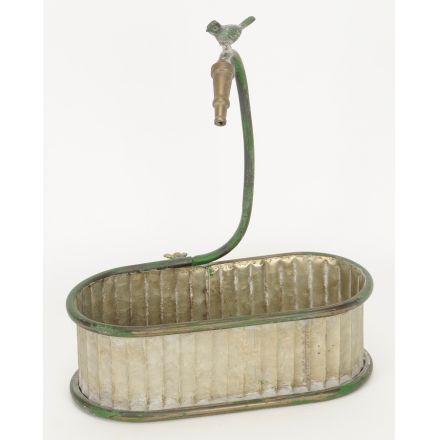 A rustic style trough planter with a tap and bird ornament. This item has a rustic, distressed finish.