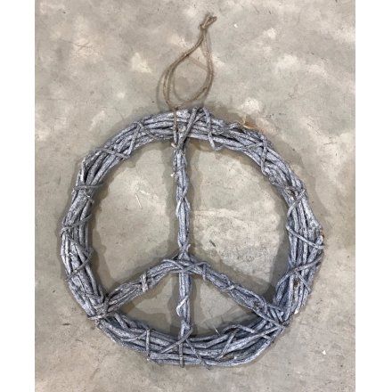 A rustic style rattan wreath in the peace design. An on trend item for the home or garden.