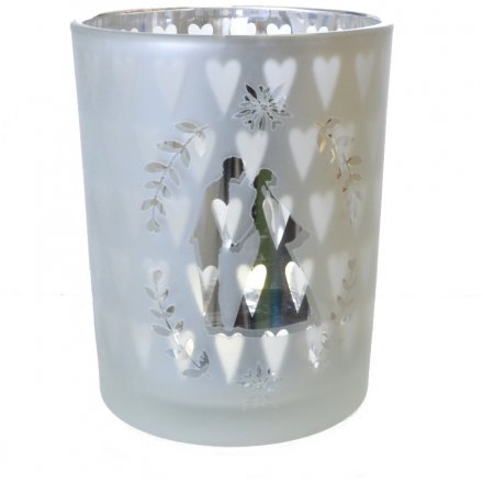 A glass silver tealight holder with hearts and kissing couple