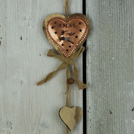 A rustic style copper garland in a heart design with reindeer cut out, rustic bells and a hessian bow.