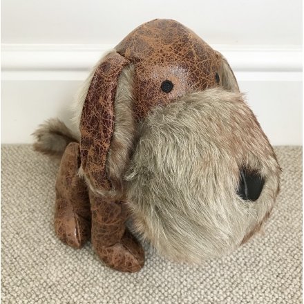 A charming little faux leather sitting dog doorstop, complete with a faux fur snout and distressed look 