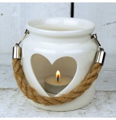  A small decorative porcelain lantern with a heart cut decal and rope handle 