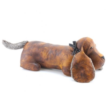 A rustic style faux leather dachshund doorstop with faux fur ears and tails. Complete with a chic bow.