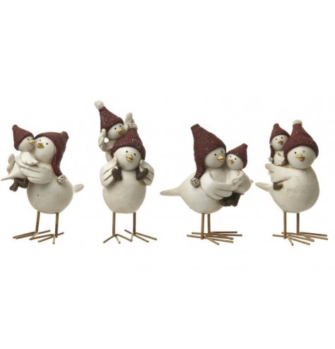 Assorted parent and child Christmas bird figures, each with red winter hats and metal legs.