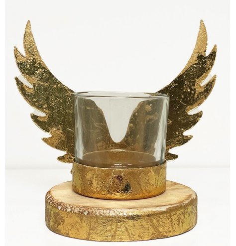 A unique candle holder with antique inspired gold metal angel wings