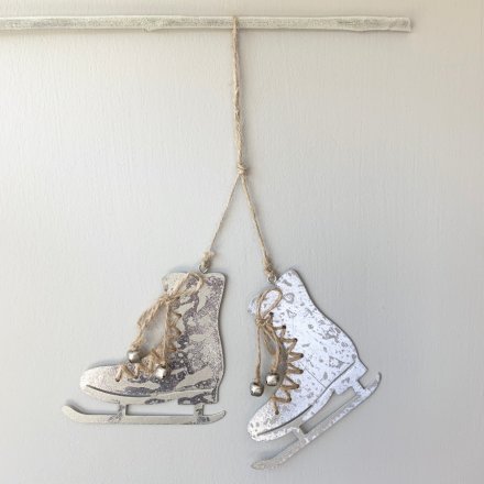 A pair of silver metal hanging skates with jute string laces and silver bells. A unique tree ornament.