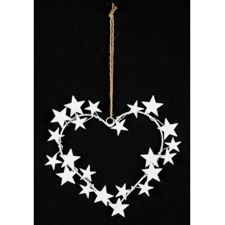 A beautifully rustic heart shaped hanging decoration covered with metal stars and hung from a jute string 