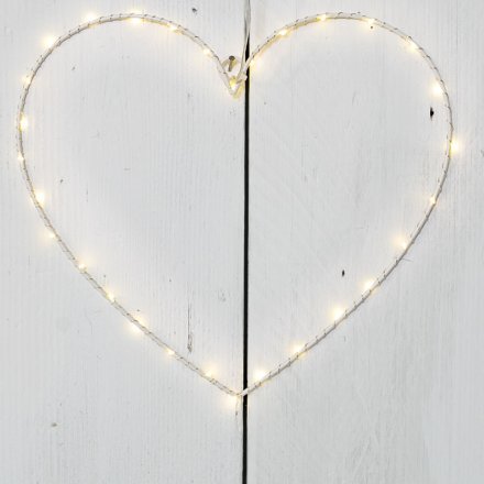 A hanging white heart decoration with warming glow LED light detail