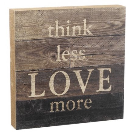 A rustic wooden panel sign with a sentiment LOVE slogan.