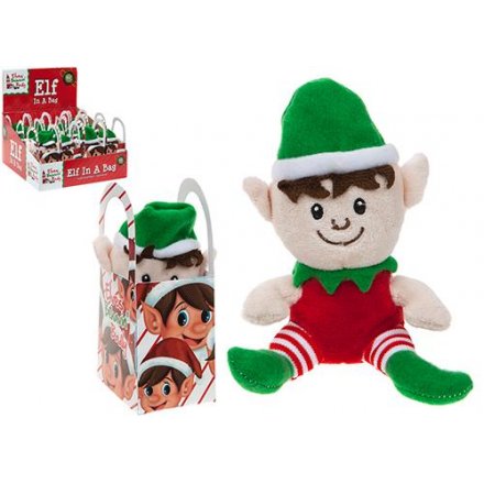 A christmas elf soft toy in carrier bag