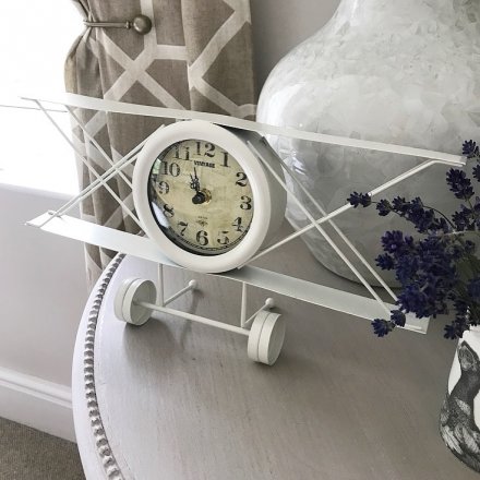  A quirky plane styled clock, set in style with a shabby chic cream pain 