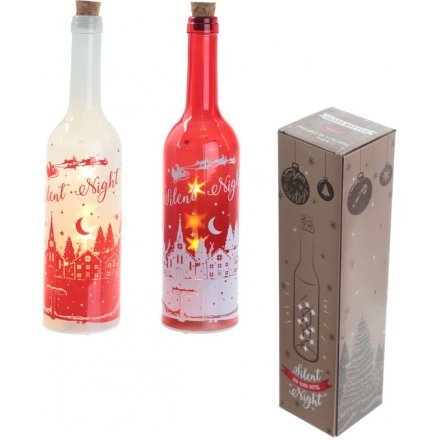 A beautiful assortment of a red and white glass bottle, complete with a silent night village scene 