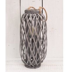 A tall grey woven lantern with chunky rope handle