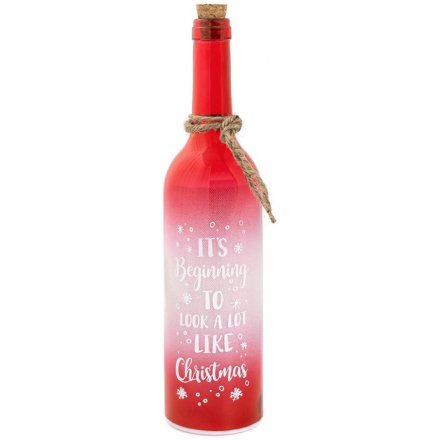 An LED red bottle with It's Beginning To Look A Lot Like Christmas quote