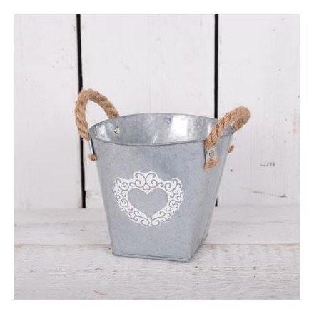 A large zinc bucket with white washed heart design