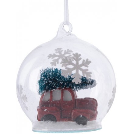 A charming glass bauble, filled with artificial snow and a delightful Christmas scene.